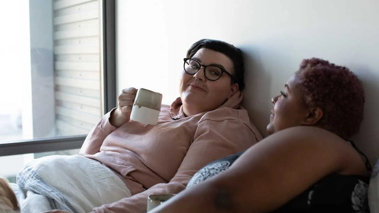 Two people sitting together in supportive conversation, representing compassionate care and understanding in eating disorder recovery